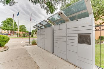 A modern building with a glass roof and a sign at Limestone Ranch Apartments, Texas